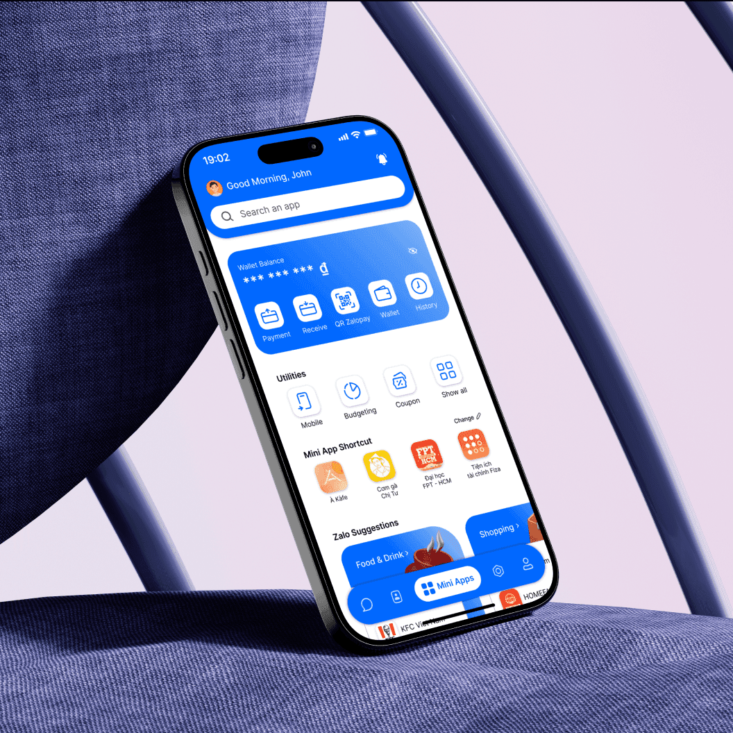 Zalo redesign on a phone against a fabric chair
